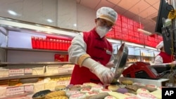 A worker packs a new year gift box with traditional pastries at a branch of Daoxiangcun, one of the best-known Chinese bakeries in Beijing, China, on Jan. 14, 2023.