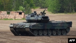 FILE - A Leopard 2 A7 main battle tank of the German armed forces Bundeswehr takes part in an educational practice in Munster, Germany, on May 20, 2019.
