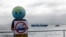 A member of Extinction Rebellion holds up a placard as the 'Akademik Alexander Karpinsky', a Russian polar explorer ship, arrives in Cape Town harbor, South Africa, Jan. 28, 2023. 