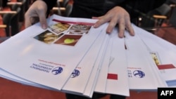 FILE - A worker lays out copies of corruption watchdog Transparency International's annual Corruption Perceptions Index prior to a press conference upon the release of the document, in Berlin, Oct. 26, 2010. 