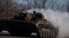 Ukrainian service members ride atop of a BMP-2 infantry fighting vehicle near a frontline in Donetsk region, Ukraine, Feb. 8, 2023.