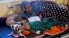 FILE - Somali displaced mother Binti Moalim Hassan lays beside her malnourished 3-year-old daughter Faduma in a hospital in Mogadishu, Oct. 25, 2022.