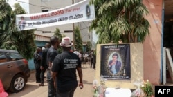 FILE - Mourners gather in the courtyard of Radio Amplitude FM, during a tribute ceremony for journalist Martinez Zogo, in the Elig Essono district of Yaounde, Cameroon, on Jan. 23, 2023.
