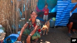 Displaced people from Myanmar live under a makeshift tent along the Thai side of the Moei River in Mae Sot, Thailand, on Feb. 7, 2022.