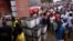 People wait to vote during the presidential election at a polling station in Monrovia, Liberia, Oct. 10, 2017. 