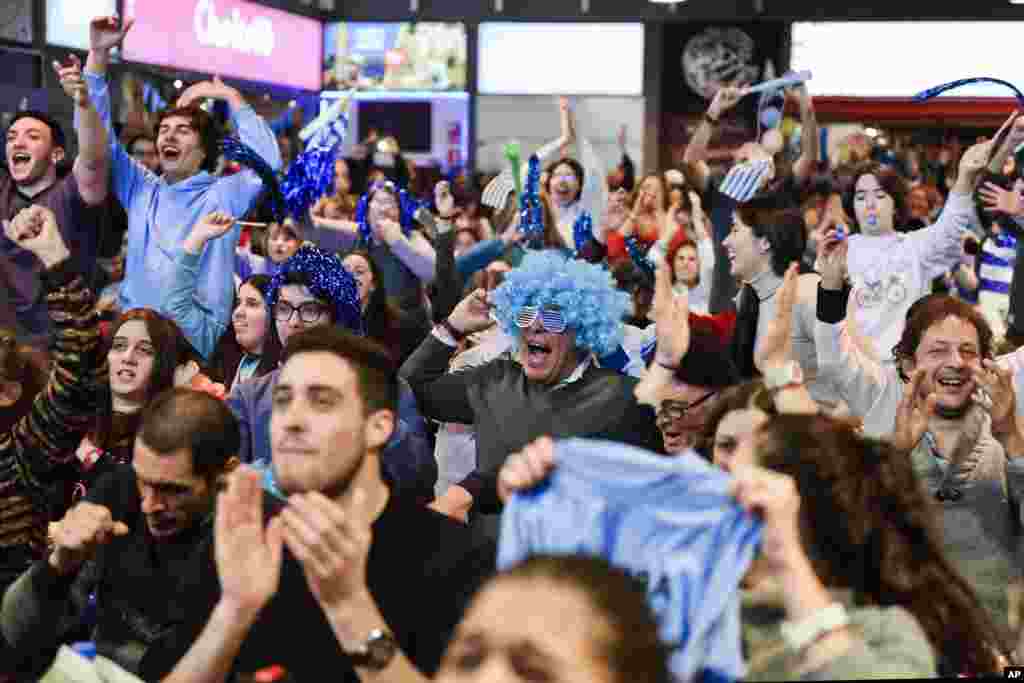 Fans of Uruguay's soccer team celebrate their team's 3-0 victory over Russia, after watching the Russia 2018 World Cup match via live broadcast in downtown Montevideo, Uruguay.