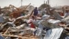 A shopkeeper surveys the wreckage of shops destroyed by a blast in a market in the capital Mogadishu, Somalia, Feb. 19, 2017. 
