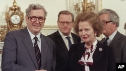 The Republic of Ireland's late Taoiseach (Prime Minister) Dr. Garret FitzGerald, left, shakes the hand of Britain's former Prime Minister Margaret Thatcher after signing the Anglo-Irish agreement at Hillsborough House, near Belfast, Northern Ireland (File