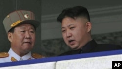 FILE - North Korean leader Kim Jong Un, right, speaks with Vice Marshal Choe Ryong Hae during a mass military parade in Kim Il Sung Square in Pyongyang, North Korea, April 15, 2012. 