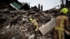 Rescuers search for bodies among remains of residential building destroyed by Russian shelling in Borodyanka, Kyiv region, Ukraine, April 10, 2022. 