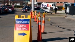 FILE - A sign points to a COVID testing site at the Cincinnati Veterans Affairs Medical Center in Cincinnati, on Jan. 3, 2022.