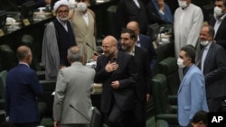 Mohammad Bagher Qalibaf, center, greets lawmakers after being elected as speaker of the parliament, in Tehran, Iran, May 28, 2020.