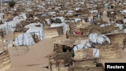 People walk through the United Nations camp in Maiduguri, Nigeria, Dec. 1, 2016. Some 4.6 million people are going hungry across northeast Nigeria, of whom two million need food aid urgently, according to the U.N.