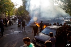 FILE - In this photo taken by an individual not employed by the Associated Press and obtained by the AP outside Iran, Iranians protest the death of 22-year-old Mahsa Amini, Tehran, Oct. 27, 2022.