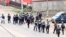 FILE - A still image taken from video shows riot police walk along a street in the English-speaking city of Buea, Cameroon Oct. 1, 2017.