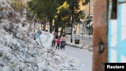 Children are seen playing near the rubble of damaged buildings in the rebel-held Bab al-Hadid neighborhood of Aleppo, Syria, Sept. 14, 2016.