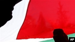 Palestinian women mark the International Women's Day and call for national reconciliation between the rival Palestinian leading factions Hamas in Gaza and Fatah in the West Bank, as they participate in a rally in Gaza city, March 8, 2011