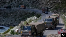 An Indian army convoy moves on the Srinagar- Ladakh highway at Gagangeer, northeast of Srinagar, Indian-controlled Kashmir, Sept. 9, 2020. China and India have been engaged in a tense standoff in the cold-desert Ladakh region. 