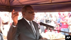 MDC President Morgan Tsvangirai addresses mourners at the burial of activist Rebecca Mafukeni in Harare, Aug. 14, 2013. 