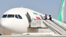 FILE - Passengers get off from a privately owned Iranian airline Mahan Air flight at the airport in Kabul on Sept. 15, 2021