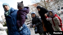 Migrants arrive at a refugee shelter in Friedenau city hall in Berlin's Tempelhof-Schoeneberg district, Germany, Feb. 26, 2016.