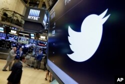 FILE - The Twitter symbol appears above a trading post on the floor of the New York Stock Exchange, July 27, 2016. Twitter, long criticized as a hotbed for online harassment, has been expanding ways to curb the amount of abuse users see.