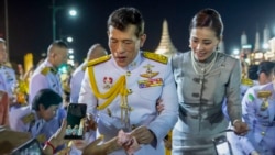 King Maha Vajiralongkorn and Queen Suthida greet supporters in Bangkok, Thailand, Sunday, Nov. 1, 2020. Under increasing pressure from protesters demanding reforms to the monarchy, Thailand's king and queen met Sunday with thousands of adoring supporters in Bangkok, mixing with c