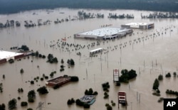 Businesses are surrounded by floodwaters from Tropical Storm Harvey, Aug. 29, 2017, in Humble, Texas.
