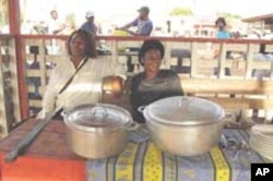 Two women vendors sell bush meat stews at market near Yaounde, Cameroon