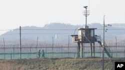 South Korean army soldiers patrol along the barbed-wire fence in Paju, near the border with North Korea, South Korea, Jan. 2, 2022.