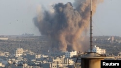 FILE - Smoke rises after an explosion in what witnesses said was an Israeli air strike in Gaza, August 20, 2014.