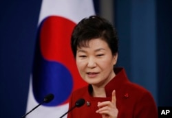 FILE - South Korean President Park Geun-hye answers a reporter's question during a news conference at the Presidential Blue House in Seoul, South Korea.