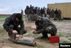 An Afghan soldier learns how to dispose of unexploded ammunition at Camp Shaheen in Mazar-i-Sharif, Afghanistan, March 26, 2017.