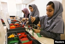 Members of Afghan robotics girls team which was denied entry into the United States for a competition, work on their robots in Herat province, Afghanistan July 4, 2017.