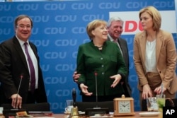 FILE - German Chancellor Angela Merkel, second from left, arrives with North Rhine-Westphalia state governor Armin Laschet (L), Hesse state governor Volker Bouffier (2nd from R), and Julia Kloeckner (R) for a board meeting of her Christian Democratic Union party at the headquarters in Berlin, Nov. 27, 2017.