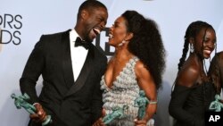 Sterling K. Brown, left, laughs with Angela Bassett, winner of the award for "Black Panther" at the 25th annual Screen Actors Guild Awards at the Shrine Auditorium & Expo Hall on Sunday, Jan. 27, 2019, in Los Angeles. 