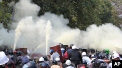 Anti-coup protesters discharge fire extinguishers to counter the tear gas fired by police during a demonstration in Naypyitaw, Myanmar, March 8, 2021. 