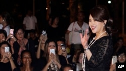 FILE - Thai Princess Ubolratana Mahidol waves outside the Grand Palace in Bangkok, Thailand, Oct. 27, 2017. 