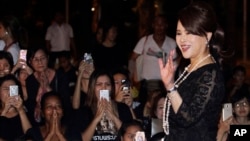 FILE - Thai Princess Ubolratana Mahidol waves outside the Grand Palace in Bangkok, Oct. 27, 2017. 