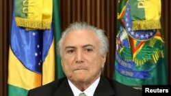 FILE - Brazil's interim President Michel Temer reacts during a meeting of the presentation of economic measures, at the Planalto Palace in Brasilia, Brazil, May 24, 2016.