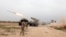FILE - Iraqi soldiers fire a rocket toward Islamic State militants on the outskirts of the Makhmour south of Mosul, Iraq, March 25, 2016. 