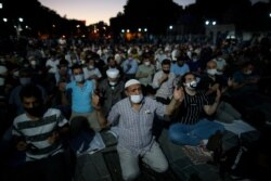 Muslims offer evening prayers outside the Hagia Sophia, in the historic Sultanahmet district of Istanbul, July 10, 2020.