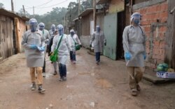 Health workers from Doctors Without Borders visit a squatters camp to conduct medical examinations for the COVID-19 in Sao Bernardo do Campo, greater Sao Paulo area, Brazil, June 3, 2020.