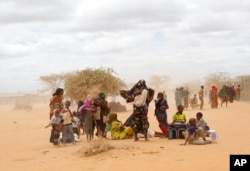 FILE - newly arrived Somali refugees wait outside a UNHCR processing center at the Ifo refugee camp outside Dadaab, eastern Kenya, 100 kilometers (62 miles) from the Somali border.