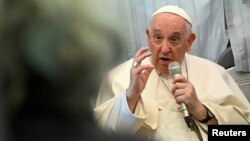 Pope Francis holds a news conference as he returns to the Vatican following his apostolic journey to Hungary, aboard the plane, April 30, 2023. 