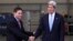 Colombia's Defense Minister Juan Carlos Pinzon (L) shakes hands with U.S. Secretary of State John Kerry during a visit to the anti-narcotics department in Bogota, August 12, 2013. 