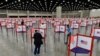 FILE - Voting stations are seen in the South Wing of the Kentucky Exposition Center in Louisville, Kentucky, June 23, 2020.