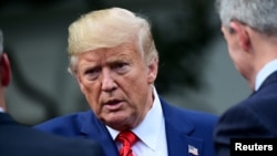 FILE - President Donald Trump speaks as he meets with sheriffs from across the country on the South Lawn of the White House in Washington, Sept. 26, 2019.