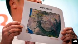 Malaysia's acting Transport Minister Hishamuddin Hussein shows the map of northern search corridor during a press conference at a hotel next to the Kuala Lumpur International Airport, in Sepang, Malaysia, March 17, 2014. 