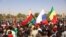 Demonstrators gather in Ouagadougou to show support to the military while holding and waiving a Russian flag in the aftermath of the coup d'etat in Burkina Faso which overthrew President Roch Marc Christian Kabore, January 25, 2022. (AFP)